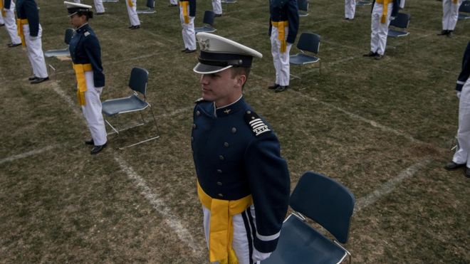 Air Force Academy cadets stand up to take an oath during their graduation ceremony on April 18, 2020