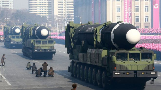 North Korean missiles on trucks.