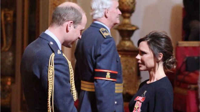 Victoria Beckham receives her OBE from Prince William