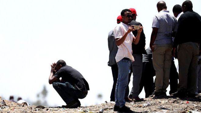 United Nations employees mourn their colleagues at a victims' commemoration ceremony at the crash site of the 302 Ethiopian Airlines plane, near Addis Ababa, Ethiopia.