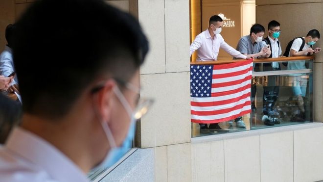 A pro-democracy demonstrator wearing a face mask holds a U.S. flag during a protest against new national security legislation in Hong Kong, China June 1, 2020.