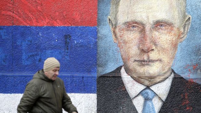 A man walks past a mural depicting Russian President Vladimir Putin in Belgrade, Serbia, 15 January 2019