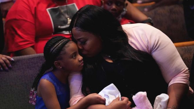 Roxie Washington holds Gianna Floyd, the daughter of George Floyd as they attend the funeral service for George Floyd