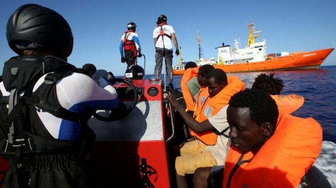 Migrants in life jackets are pictured during a rescue by the charity SOS Méditerranée
