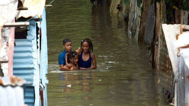 Niños en una zona inundada de Santo Domingo.