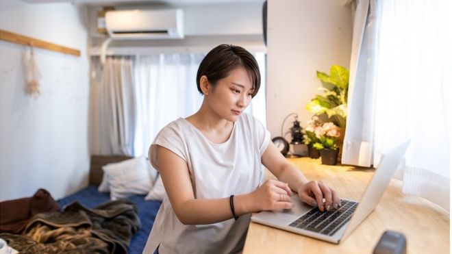 Young woman working at home in the morning - stock photo