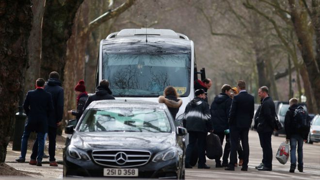 People board a van bearing diplomatic plates carrying luggage after leaving the Russian Embassy in London