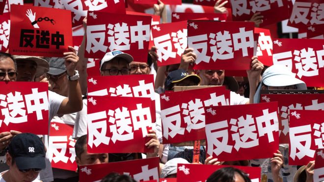 香港民陣」反送中「示威一名參加者舉起標語牌（9/6/2019）