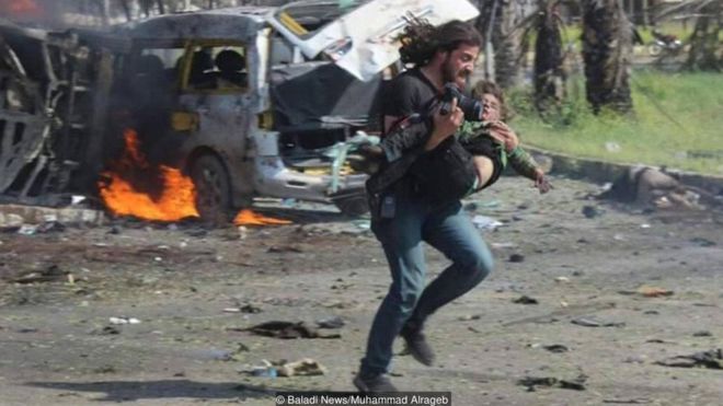 Syrian photographer Abd Alkader Habak carried a child to safety after a convoy of buses carrying evacuees from Syrian villages was bombed