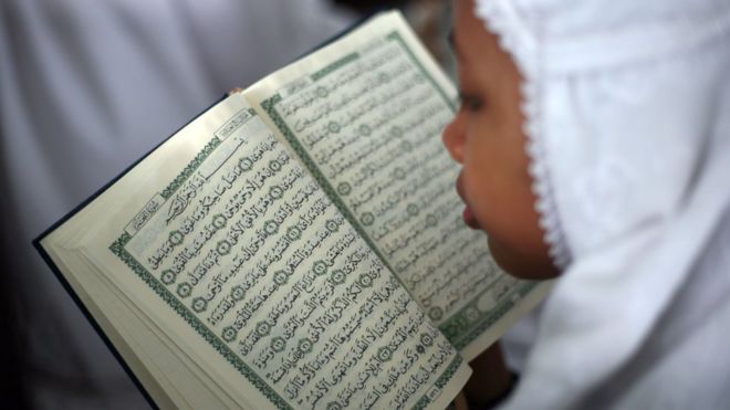 A student in Medan, Indonesia reads the Koran