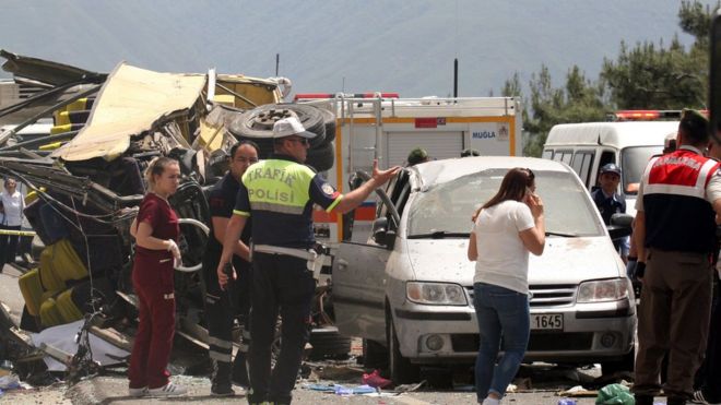 Medics and rescue workers stand at the scene after a tourist bus crashed near the southwestern holiday town of Marmaris, Turkey, May 13, 2017.