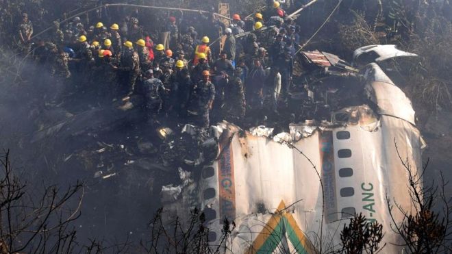 Rescue teams working near the wreckage at the crash site of a Yeti Airlines ATR72 aircraft in Pokhara, central Nepal, on 15 January 2023