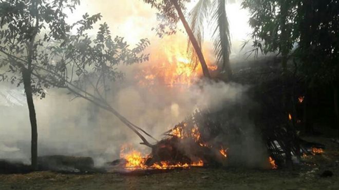 Myanmar soldiers are putting out a fire in Wapeik village located in Maungdaw on November 13, after attackers allegedly set fire to 80 houses.