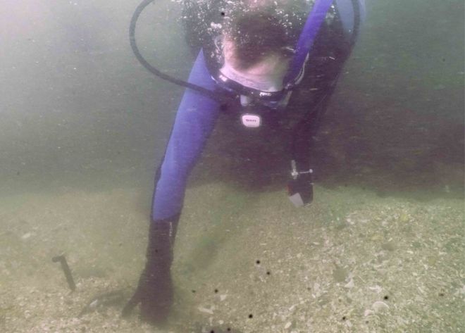 Дайвер, ищущий под водой