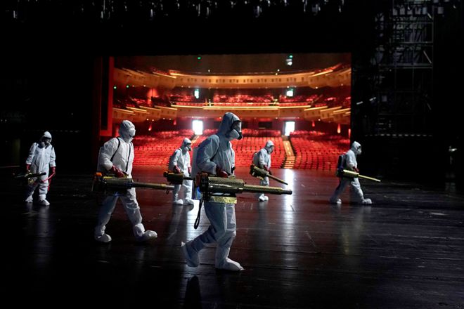 Volunteers disinfect the Qintai Grand Theatre in Wuhan