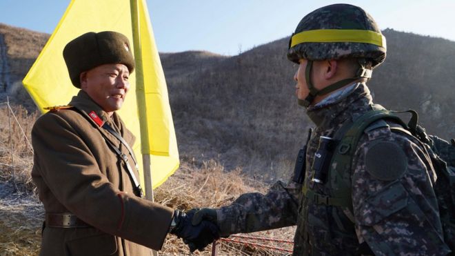 North and South Korean soldiers shaking hands