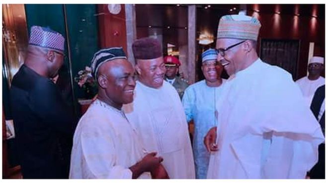 President Muhammadu Buhari, senator Ita Enang and senator Godwill Akpabio dey gist.
