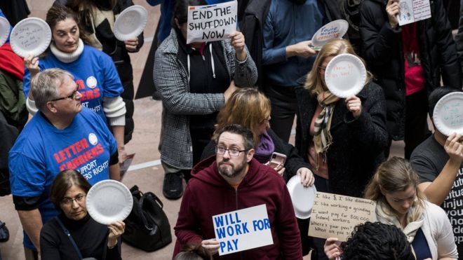 Federal workers protest in a Senate office building on Wednesday