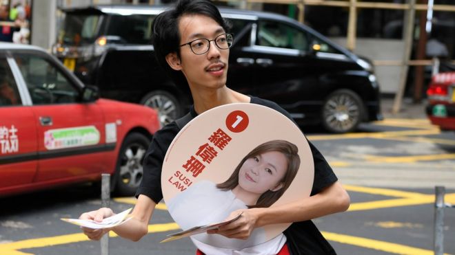A man campaigns for Susi Law, a candidate in Sunday's district council elections in Hong Kong, China November 23, 2019