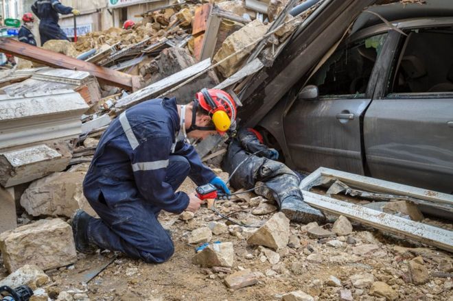 На этой раздаточной фотографии, выпущенной BMPM / SM, пожарные работают и убирают щебень на месте обрушения двух зданий 5 ноября 2018 года в Марселе