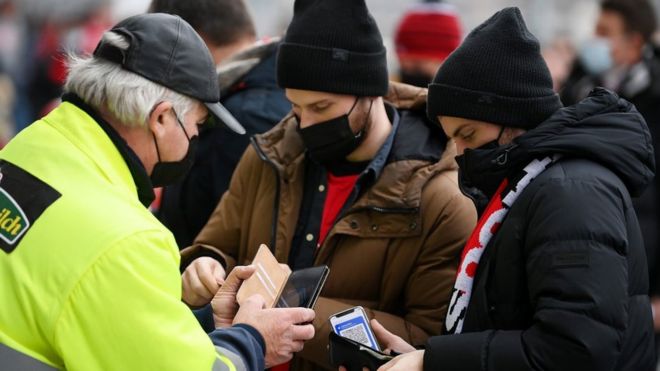Fans arrive at the stadium and have their devices scanned as part of the 2G COVID-19 protocols prior to the Bundesliga match between Sport-Club Freiburg and Eintracht Frankfurt at SC-Stadion on November 21, 2021 in Freiburg im Breisgau, Germany.