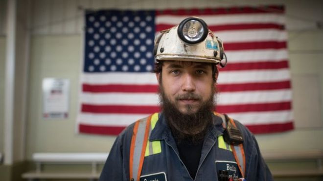 A miner in front of the American flag