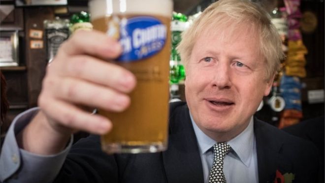 Boris Johnson holding up a pint of beer