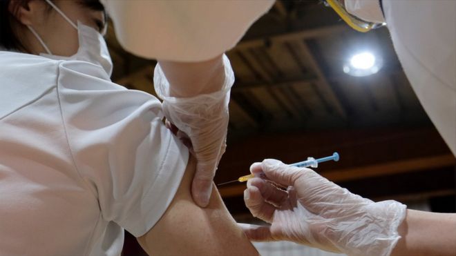 A healthcare worker gets the vaccine in South Korea
