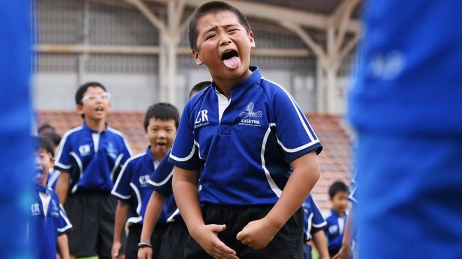 Children perform a haka in front of New Zealand's players during a fans event at Kashiwanoha Park Stadium in Kashiwa