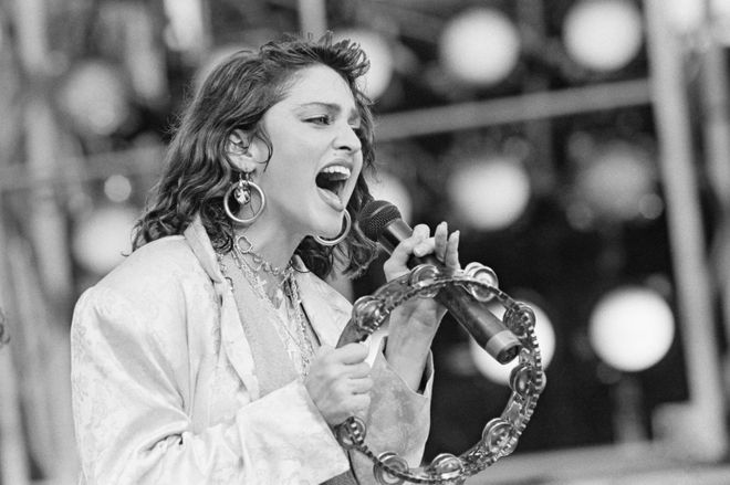 Madonna sings during the U.S. Live Aid concert held to raise money for famine victims in Ethiopia at the John F. Kennedy Stadium in Philadelphia
