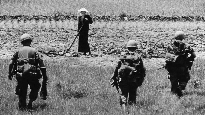 Soldiers approach an agricultural worker