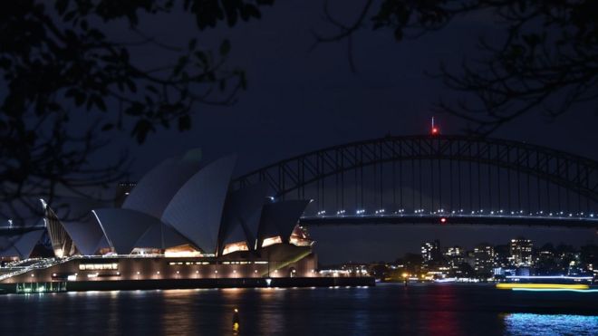 Sydney Harbour Bridge and the Opera House are plunged into darkness for the Earth Hour environmental campaign on March 24, 2018.