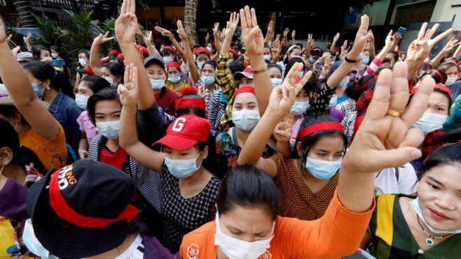 Protesters flash the three-finger salute, a symbol of resistance, as they demonstrate against the military coup in Yangon