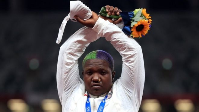 Shot put silver medallist Raven Saunders of the United States gestures on the podium