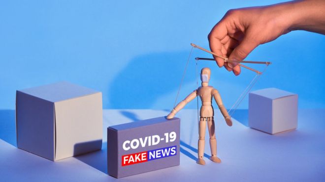 Ilustração gráfica mostra boneco de madeira controlado por mão, como um fantoche, ao lado de caixa que diz: 'Covid-19 Fake news'