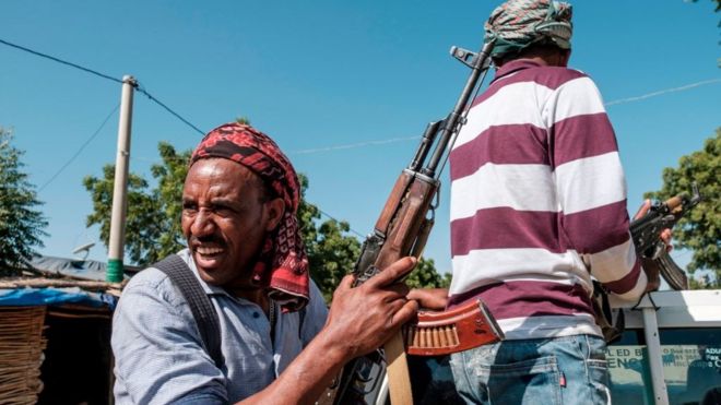 Members of the Amhara militia ride in the back of a pick up truck, in Mai Kadra, Ethiopia, on November 21, 2020. - Amharas and Tigrayans were uneasy neighbours before the current fighting, with tension over land sparking violent clashes. That Mai-Kadra is now being run,at least temporarily, by Amharas provides relief to Amharas, even as it deepens Tigrayan fears of occupation. (Photo by EDUARDO SOTERAS / AFP) (Photo by EDUARDO SOTERAS/AFP via Getty Images)
