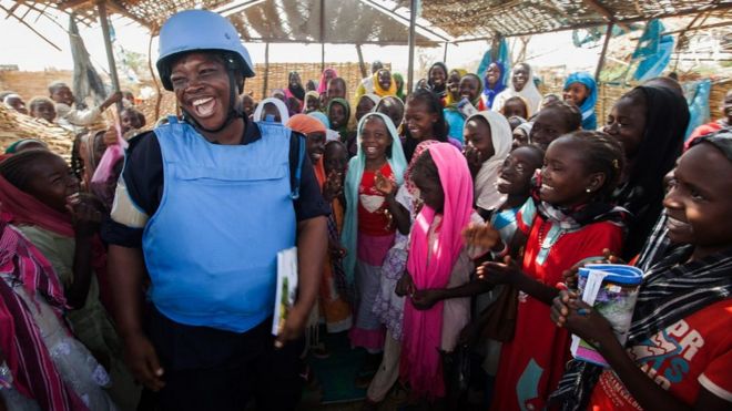 Ghanaian UN policewoman with refugee children in Darfur, Sudan, May 2014
