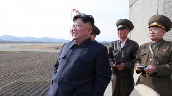 Kim Jong-un watches a flight training on April 16 with military personnel assisting him