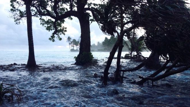 A file photo taken 3 March 2014 shows a high tide energised by storm surges washing across Ejit Island in Majuro Atoll, Marshall Islands