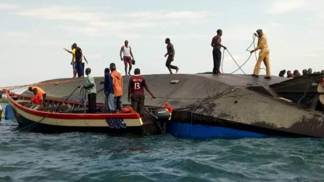 Volunteers work at the scene of a capsizing in Tanzania