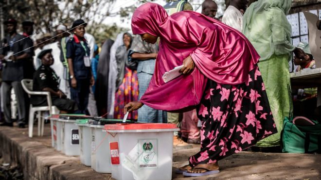 A Nigerian woman casts her vote for a candidate in the presidential election at Agiya