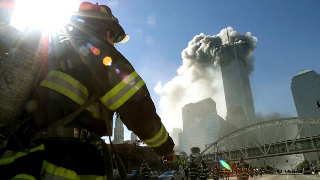 Firefighters walk towards one of the tower at the World Trade Center before it collapsed after a plane hit the building September 11, 2001 in New York City.
