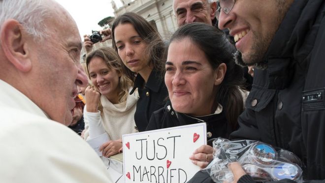 Pope Francis greets a newly married couple at the Vatican, 23 March