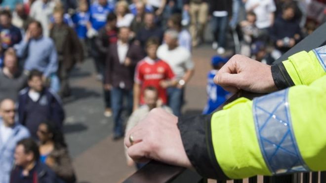 Police officer watches crowd