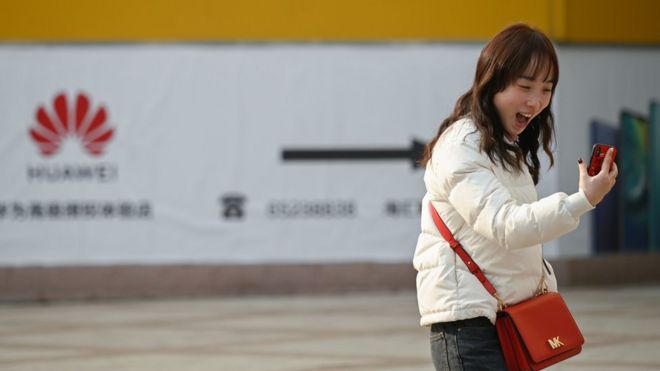 Woman in China happy with her smartphone.