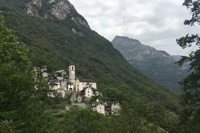 Vista de Corippo à distância, com casas de pedras encravadas em montanha