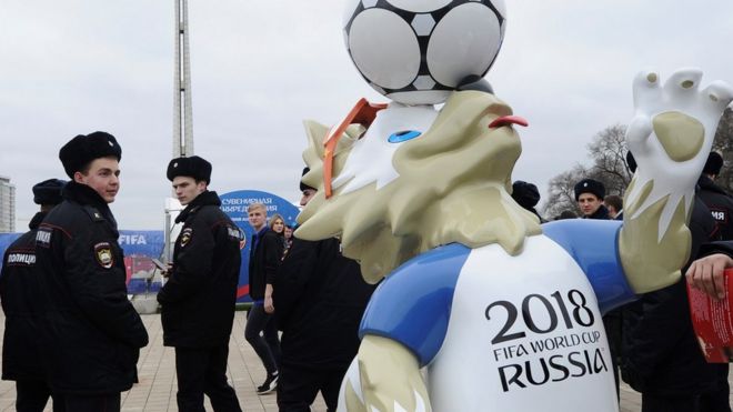 Police officers walk past the official mascot for the 2018 FIFA World Cup Russia, Zabivaka during the opening of the Football Park in Rostov-on-Don, Russia March 31, 2018