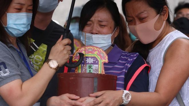 Relatives of the victims grieve near the site of the deadly accident, a day after a train derailed at a tunnel north of Hualien, Taiwan April 3, 2021