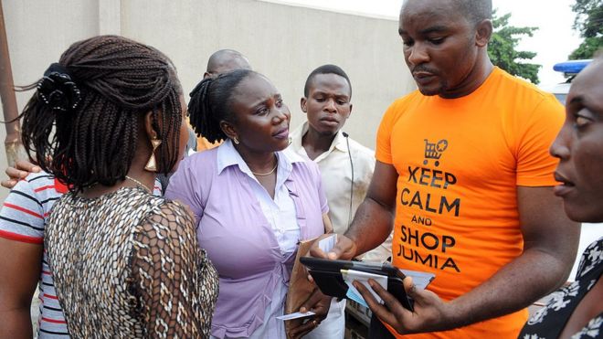 A Jumia saleman tries to market products to bystanders in Lagos on June 12, 2013.