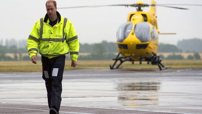 The Duke of Cambridge walks on the runway as he begins his new job with the East Anglian Air Ambulance (EAAA) at Cambridge Airport on July 13, 2015.